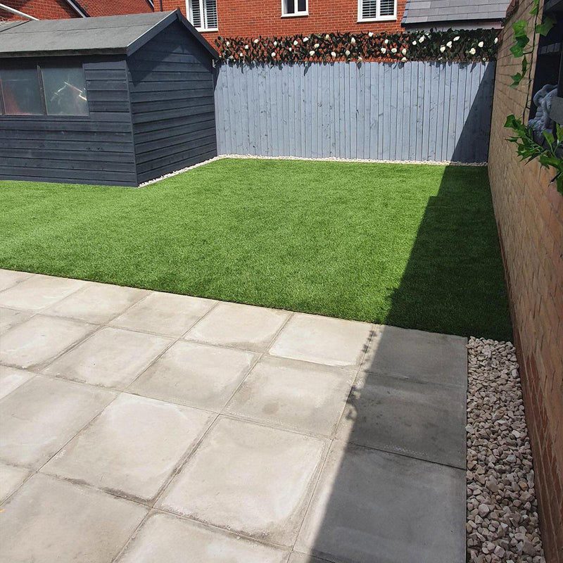 Artificial Grass in back garden surrounded by fencing with a shed