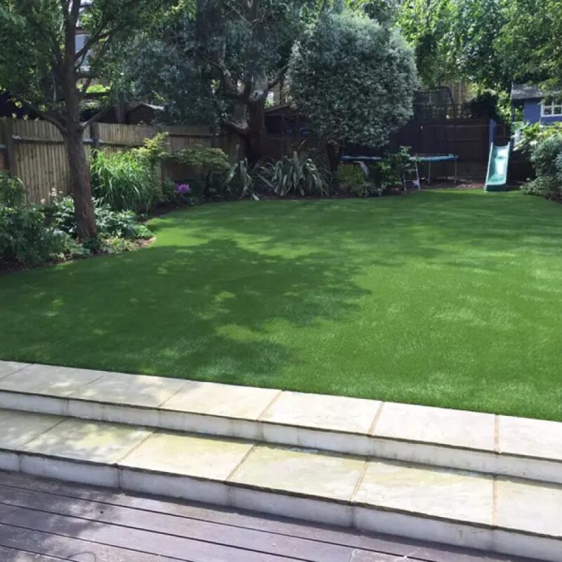Artificial Grass in back garden surrounded by plants